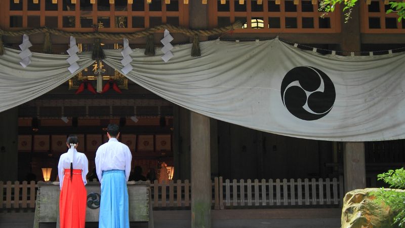 A-man-and-a-woman-worshiping-at-a-shrine