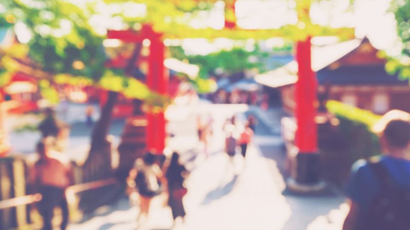 A-slightly-blurry-photo-of-the-shrine's-torii-gate-and-worshipers